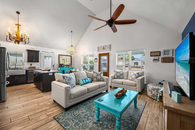 Kick your sandals off and sink into the couch — the ceiling opens the whole room up, so nobody's stuck squeezed in a corner.