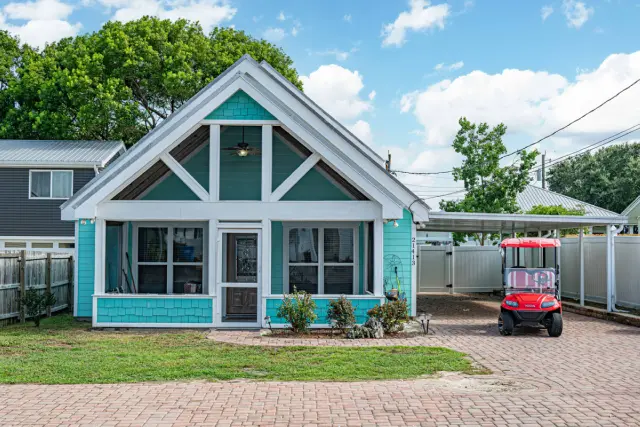 See the whole front of the house at once — bright, beachy, and exactly what a PCB porch should look like.
