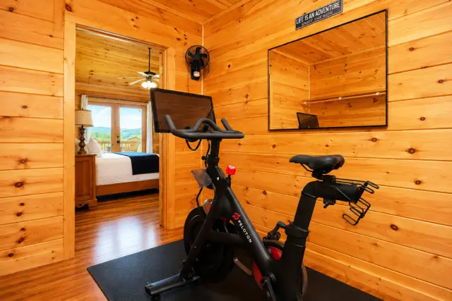 Your Peloton, your playlist, your mountain morning — the private fitness nook off the king suite is steps from the bed and has a view to match. Sign in with your own account and ride before the rest of the house wakes up.